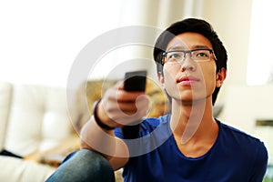 Man sitting on couch watching tv at home