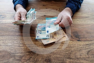 Man sitting at desk counting money