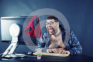 Man sitting at desk looking on computer screen