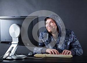 Man sitting at desk looking on computer screen