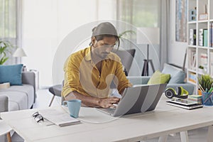 Man sitting at desk and working with his laptop