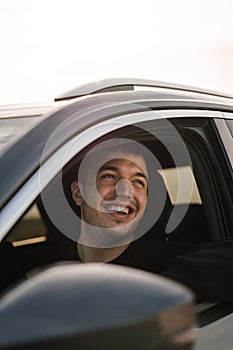 Man sitting in the driver's seat of a car