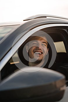 Man sitting in the driver's seat of a car