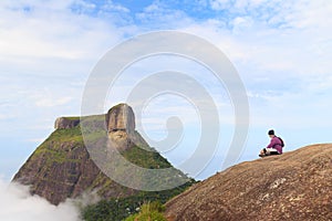 Man sitting on edge of mountain Pedra Bonita, Pedra da Gavea photo