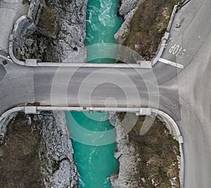 Man sitting on the edge of Napoleon bridge over river Soca. Kobarid, Slovenia.