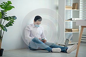 Man sitting on the floor and looking demotivated