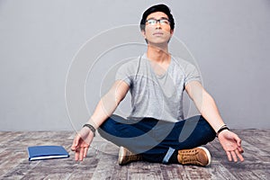 Man sitting on the floor and meditating