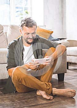 Man Sitting on Floor With Tablet