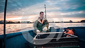 Man Sitting At The Front Of Driving Boat