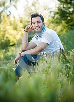 Man sitting on grass in forest