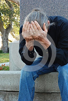 Man sitting at gravesite