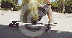 Man sitting on his longboard at a skate park