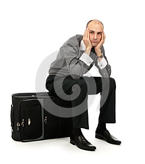 Man sitting on his luggage