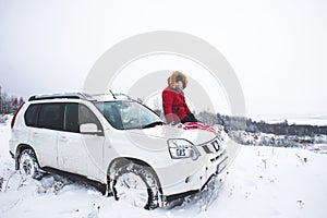 man sitting on the hood of the suv car with flag of usa. car travel concept