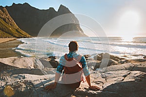 Man sitting on Kvalvika beach enjoying ocean view travel vacations eco tourism photo