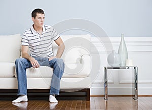 Man Sitting on Living Room Couch