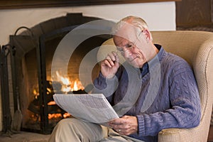 Man sitting in living room by fireplace