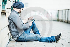 Man sitting and looking his tablet