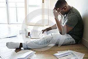 Man sitting and managing the debt photo