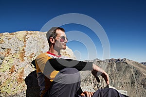 Man Sitting On Mountain Top