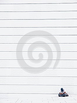 Man sitting near wall of Oslo opera house, Norway