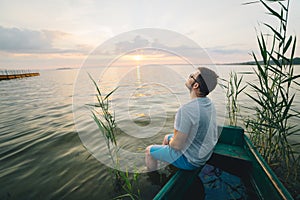 Man sitting in the old boat thinking