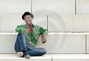 Man sitting outdoors with mobile phone