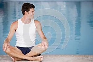 Man sitting poolside smiling