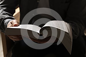 Man sitting and reading holy Bible, closeup