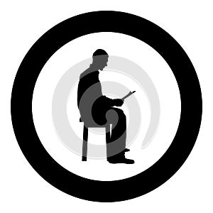 Man sitting reading Silhouette concept learing document icon black color illustration in circle round