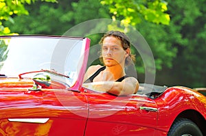 Man sitting in a red car