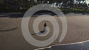 Man sitting in saddle of a bike and watching the ocean