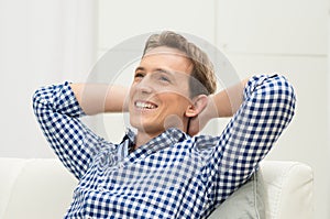 Man Sitting On Sofa Contemplating