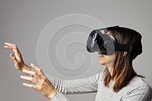 Man Sitting On Sofa At Home Wearing Virtual Reality Headset