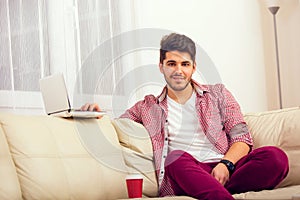 Man sitting on sofa with laptop