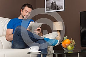 Man sitting on sofa relaxed and smiling.