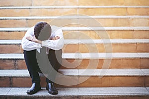 Man sitting staircase way pedestrian overpass. stress people compression in office feel stressful