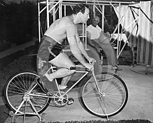 Man sitting on a stationary bicycle doing exercise