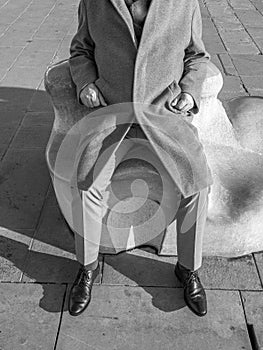 Man sitting on a stone bench structure