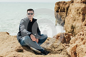 Man sitting on the stone. Travel concept