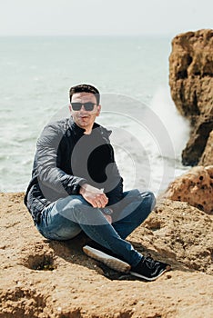 Man sitting on the stone. Travel concept