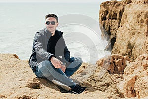 Man sitting on the stone. Travel concept