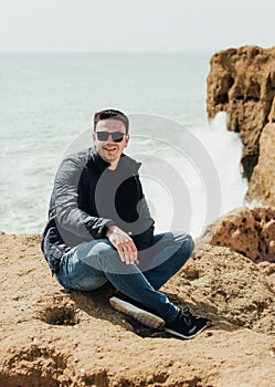 Man sitting on the stone. Travel concept