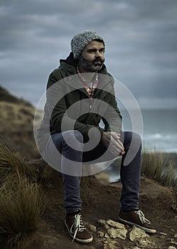Man sitting on a stunning rugged coast