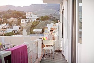 Man sitting on the terrace of a hotel