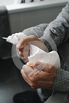 man sitting in the toilet grabbing the toilet paper