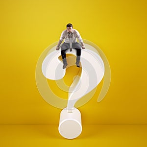 Man sitting on top of a big white question mark on a yellow background