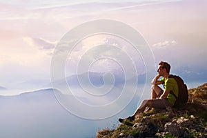 Man sitting on top of mountain, achievement or opportunity concept, hiker photo