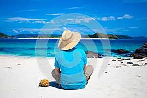 Man sitting on the tropical island beach