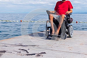 Man sitting in a wheelchair on the beach